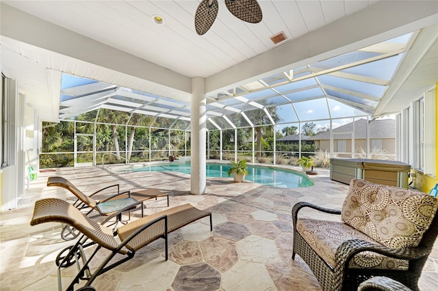 view of swimming pool with an outdoor living space, ceiling fan, glass enclosure, a patio, and a hot tub