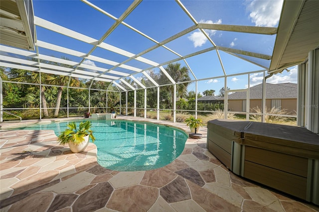 view of swimming pool with glass enclosure, a patio area, and a hot tub