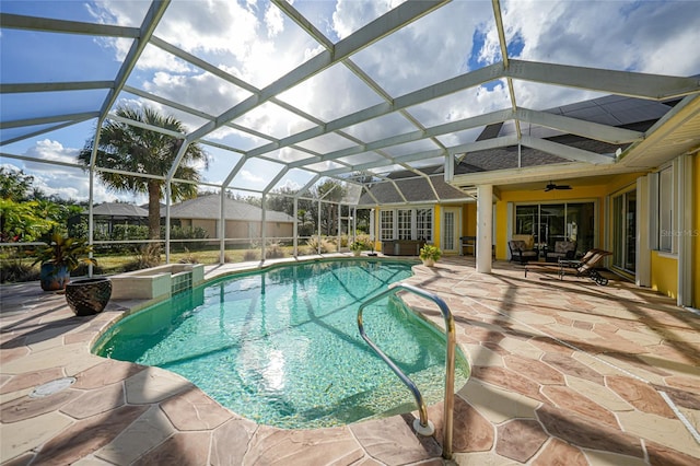 view of pool with a patio, ceiling fan, and a lanai