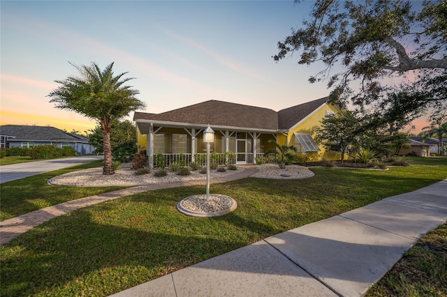 1064 Harbour Way Pl, Punta Gorda, FL 33983 - view of front facade featuring curved driveway, a front yard, and covered porch