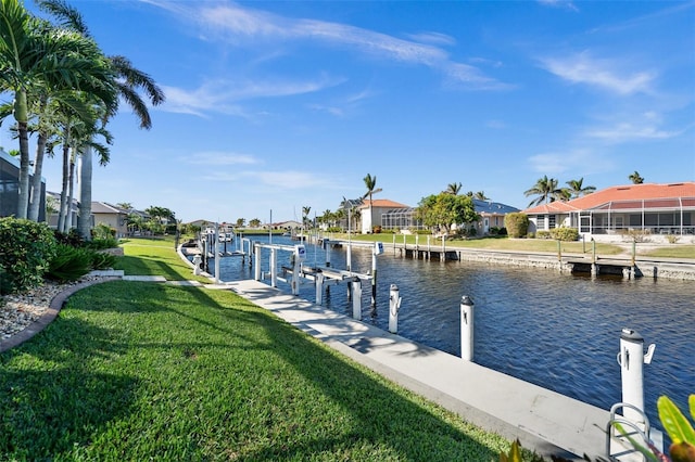 dock area with a yard and a water view