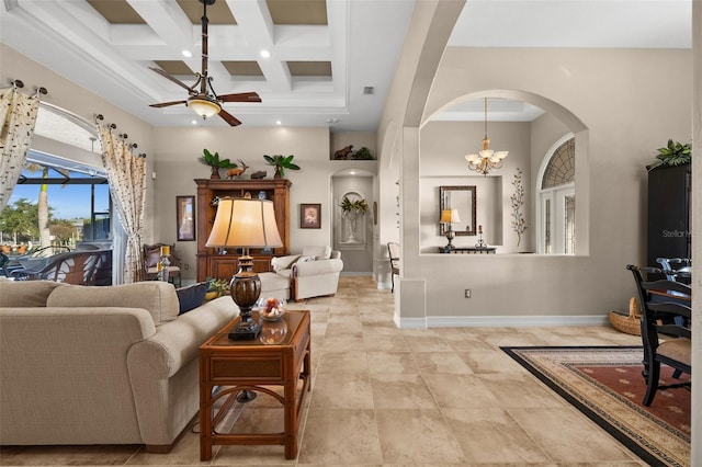 living room featuring beamed ceiling, a high ceiling, ceiling fan with notable chandelier, and coffered ceiling