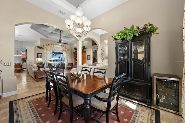 tiled dining space with beamed ceiling, wine cooler, an inviting chandelier, and coffered ceiling