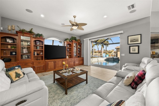 tiled living room with ceiling fan