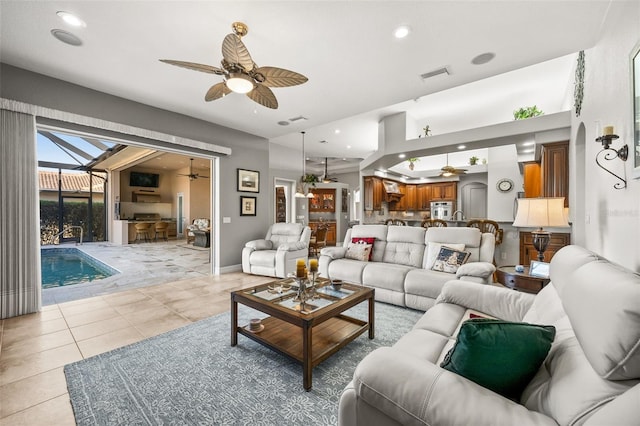 living room featuring ceiling fan and light tile patterned flooring