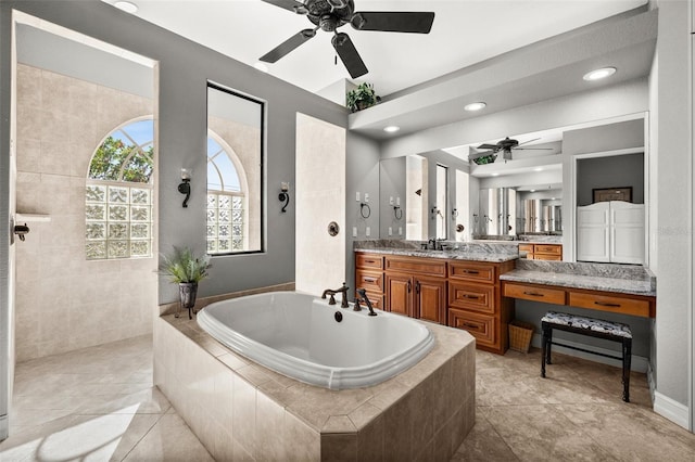 bathroom featuring ceiling fan, tile patterned flooring, vanity, and shower with separate bathtub