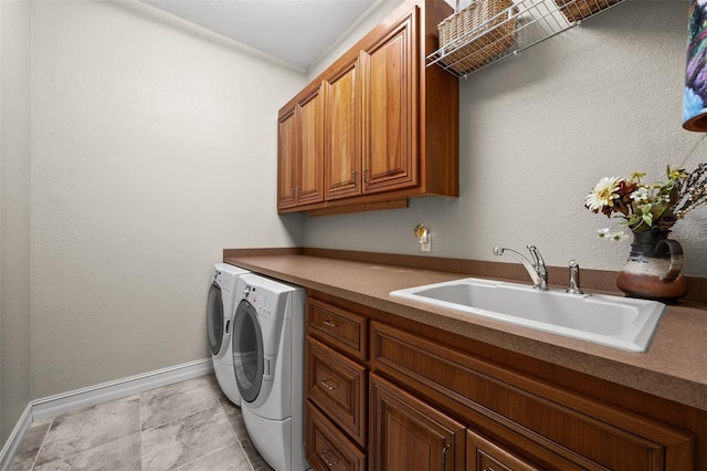 washroom featuring cabinets, independent washer and dryer, and sink