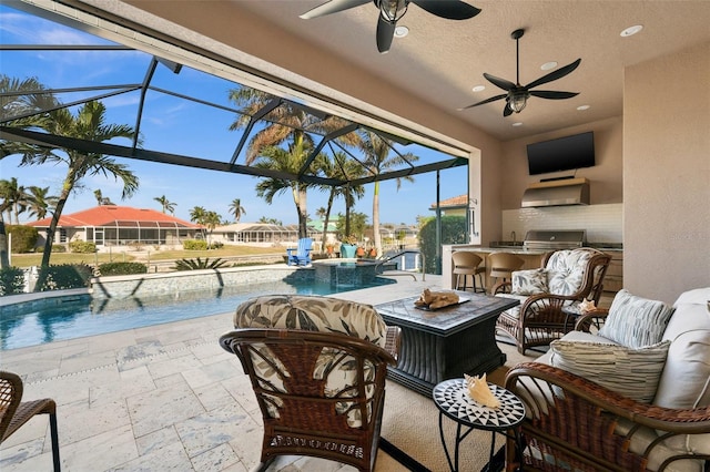 view of patio with ceiling fan, exterior kitchen, a bar, glass enclosure, and grilling area