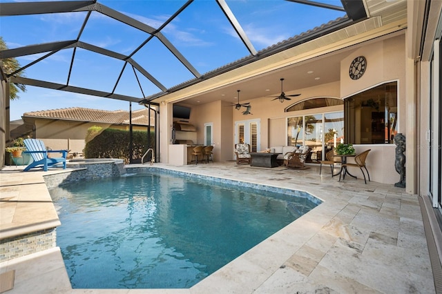 view of swimming pool with an in ground hot tub, outdoor lounge area, ceiling fan, glass enclosure, and a patio area