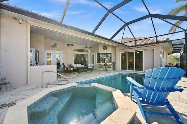 view of swimming pool with an in ground hot tub, french doors, outdoor lounge area, ceiling fan, and a patio area