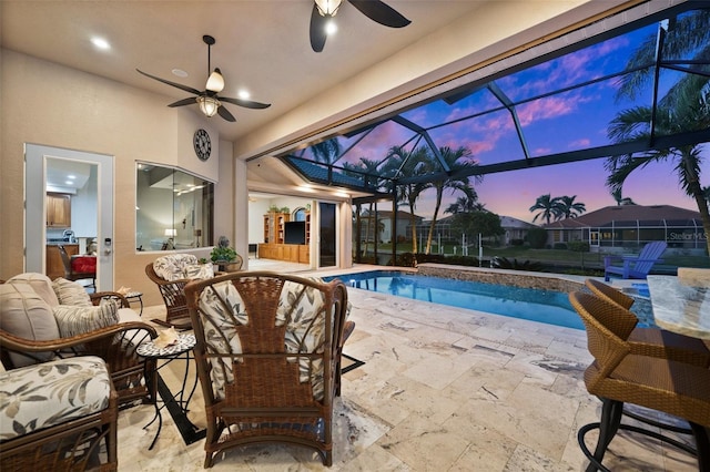 pool at dusk with ceiling fan