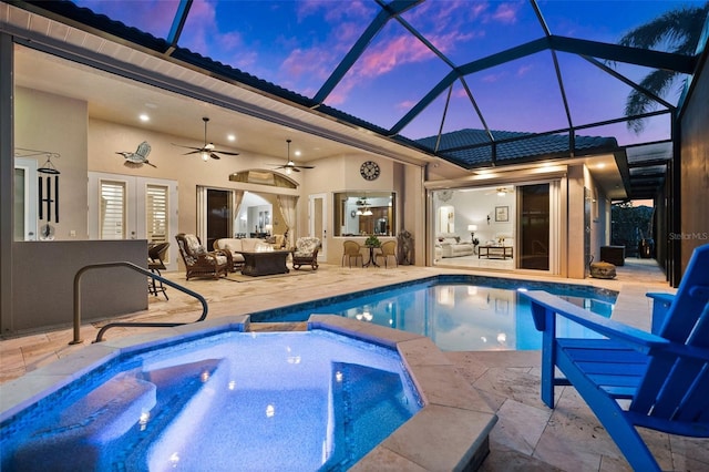 pool at dusk with outdoor lounge area, ceiling fan, french doors, a patio area, and an in ground hot tub