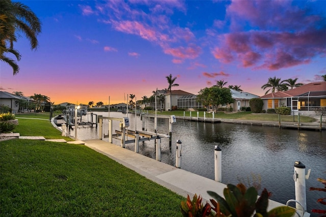 dock area featuring a yard and a water view