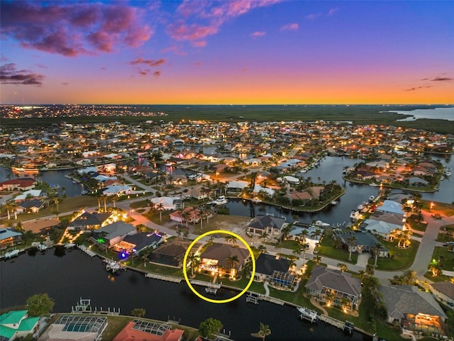 aerial view at dusk with a water view