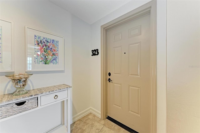 doorway with light tile patterned flooring