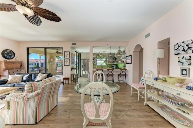 dining area with ceiling fan and light hardwood / wood-style flooring