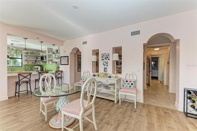 dining space with light hardwood / wood-style floors