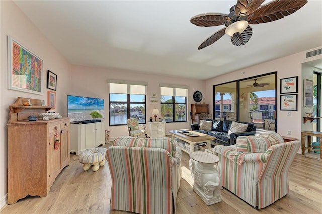 living room with ceiling fan and light hardwood / wood-style floors