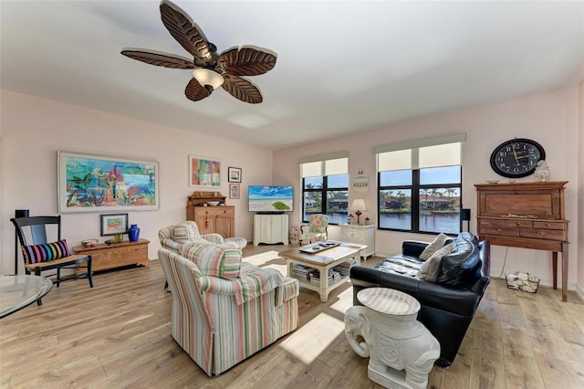 living room featuring ceiling fan and light hardwood / wood-style flooring