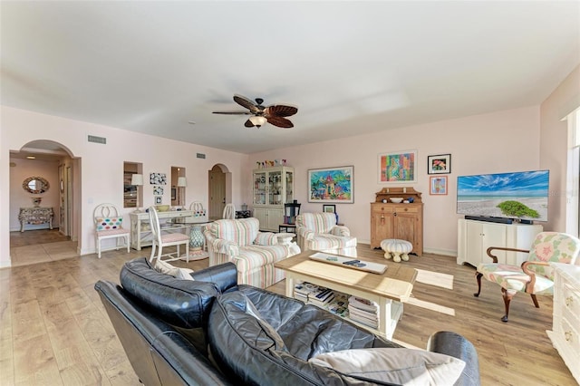 living room with light hardwood / wood-style floors and ceiling fan