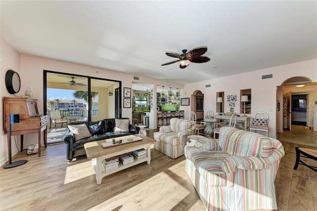 living room featuring ceiling fan and light hardwood / wood-style flooring