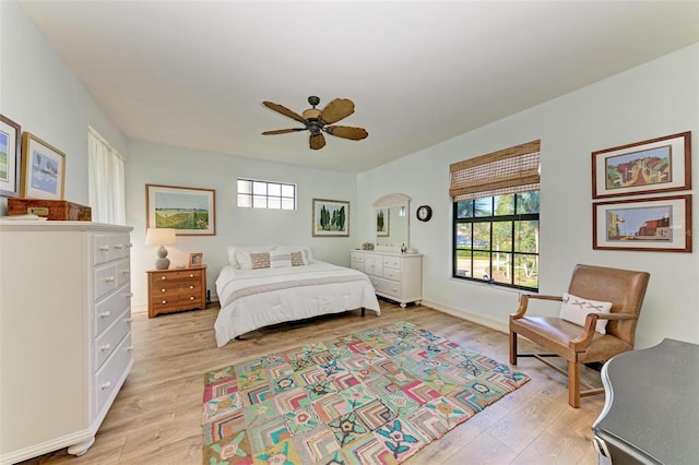 bedroom with light wood-type flooring and ceiling fan