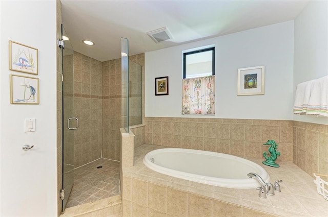 bathroom featuring separate shower and tub