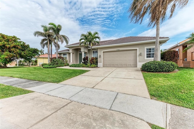 view of front of house with a garage and a front yard