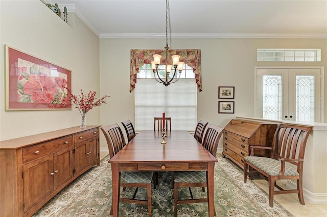 dining space with a notable chandelier, crown molding, and french doors