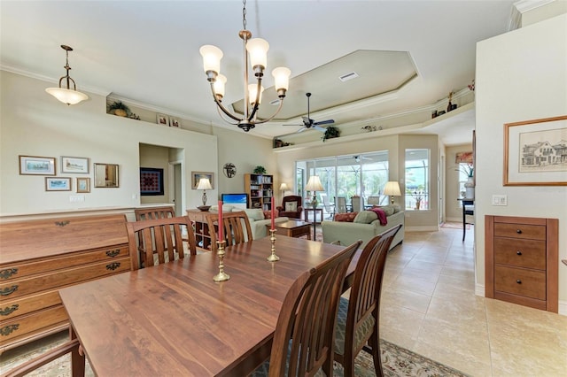 tiled dining area with ceiling fan with notable chandelier, a tray ceiling, and crown molding