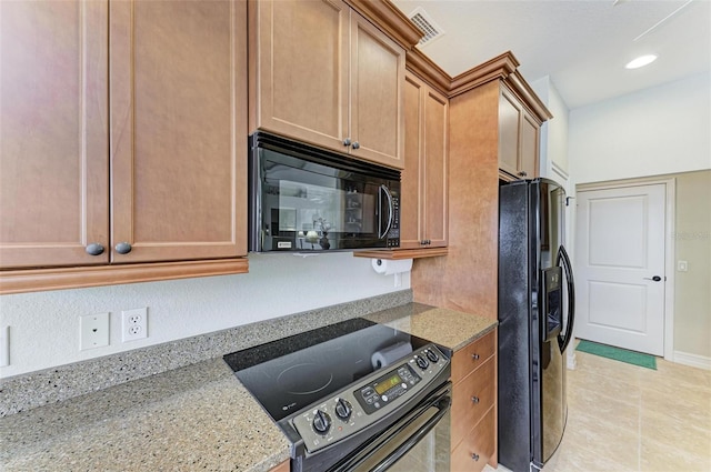 kitchen with light stone counters and black appliances