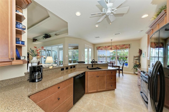 kitchen with ceiling fan, sink, light stone counters, decorative light fixtures, and black appliances