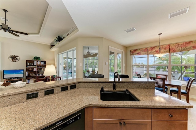 kitchen featuring light stone counters, sink, and plenty of natural light