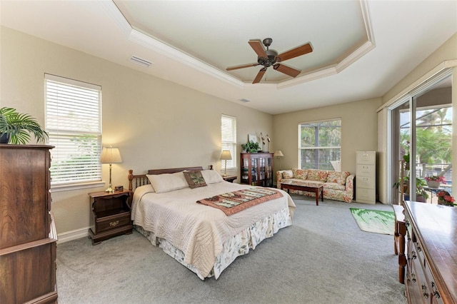 bedroom featuring access to exterior, light colored carpet, a raised ceiling, and ceiling fan