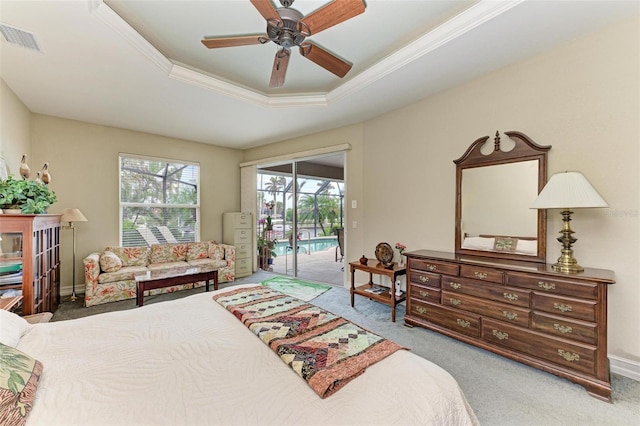 bedroom featuring ceiling fan, light colored carpet, access to outside, and a tray ceiling