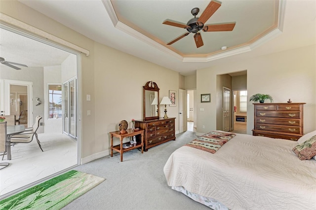 carpeted bedroom featuring ceiling fan and a tray ceiling