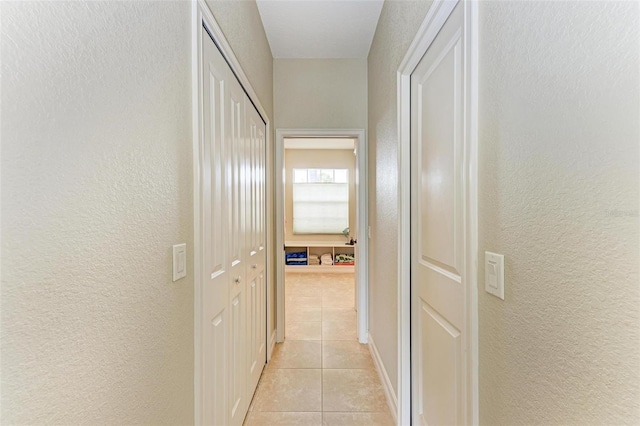 hall with light tile patterned floors