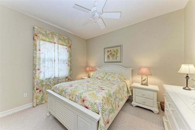 bedroom with ceiling fan and light carpet