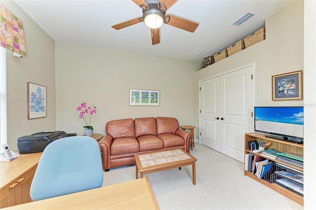 carpeted living room with ceiling fan