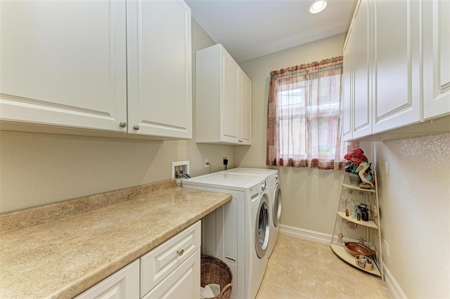 laundry area featuring cabinets, separate washer and dryer, and light tile patterned floors