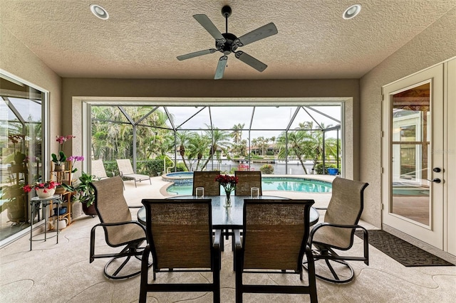 sunroom / solarium featuring ceiling fan and a swimming pool