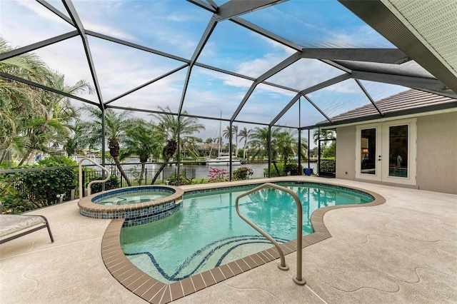 view of swimming pool with french doors, a water view, a lanai, an in ground hot tub, and a patio area