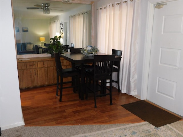 dining area with ceiling fan and wood-type flooring