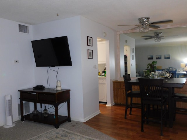 dining area with dark hardwood / wood-style floors and ceiling fan