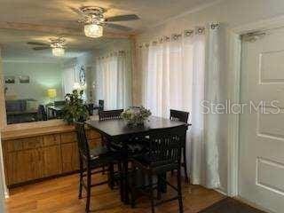 dining space featuring ceiling fan and wood-type flooring