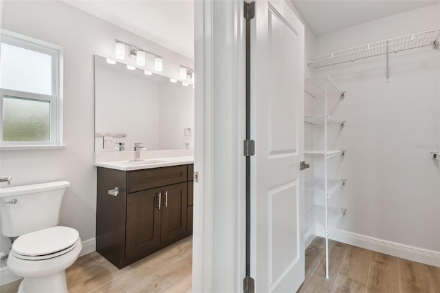 bathroom featuring hardwood / wood-style flooring, vanity, and toilet