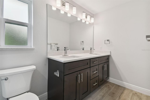 bathroom featuring hardwood / wood-style floors, vanity, and toilet