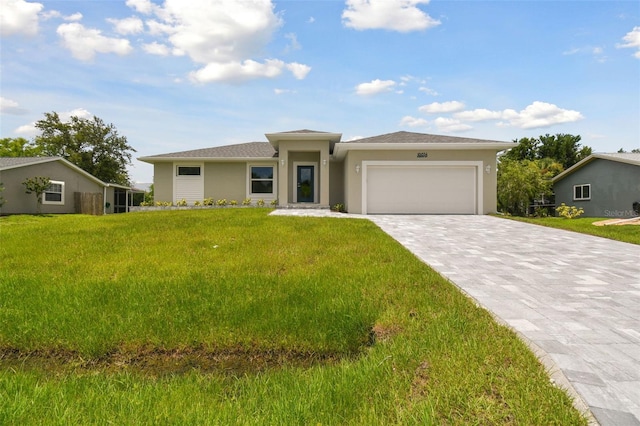 18854 Ackerman Ave, Port Charlotte, FL 33948 - prairie-style house featuring a garage, decorative driveway, stucco siding, and a front lawn