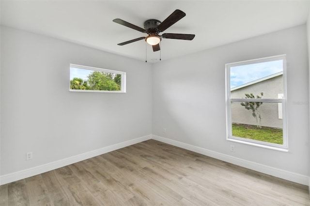 18854 Ackerman Ave, Port Charlotte, FL 33948 - unfurnished room with healthy amount of natural light, light wood-type flooring, and ceiling fan
