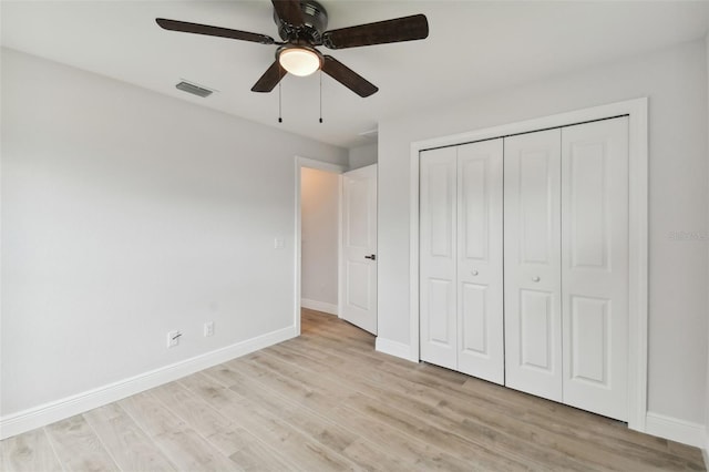 unfurnished bedroom with ceiling fan, light hardwood / wood-style floors, and a closet